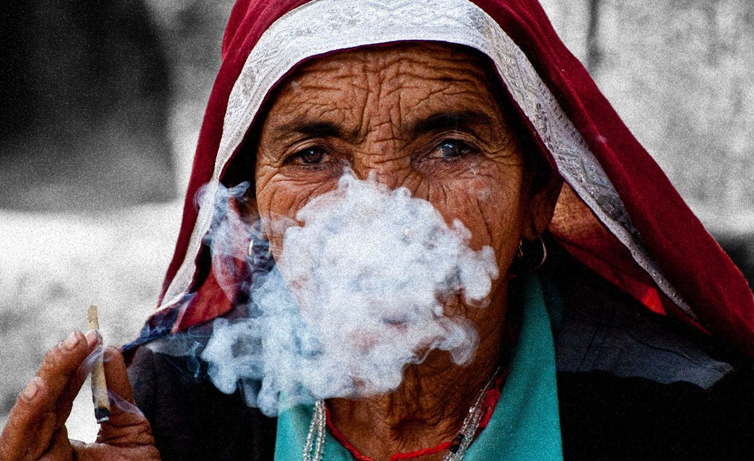 Closeup of an old woman smoking—taken from the Gender Curriculum & Media Fellowship designed by Newsworthy.Studio for Global Health Strategies.