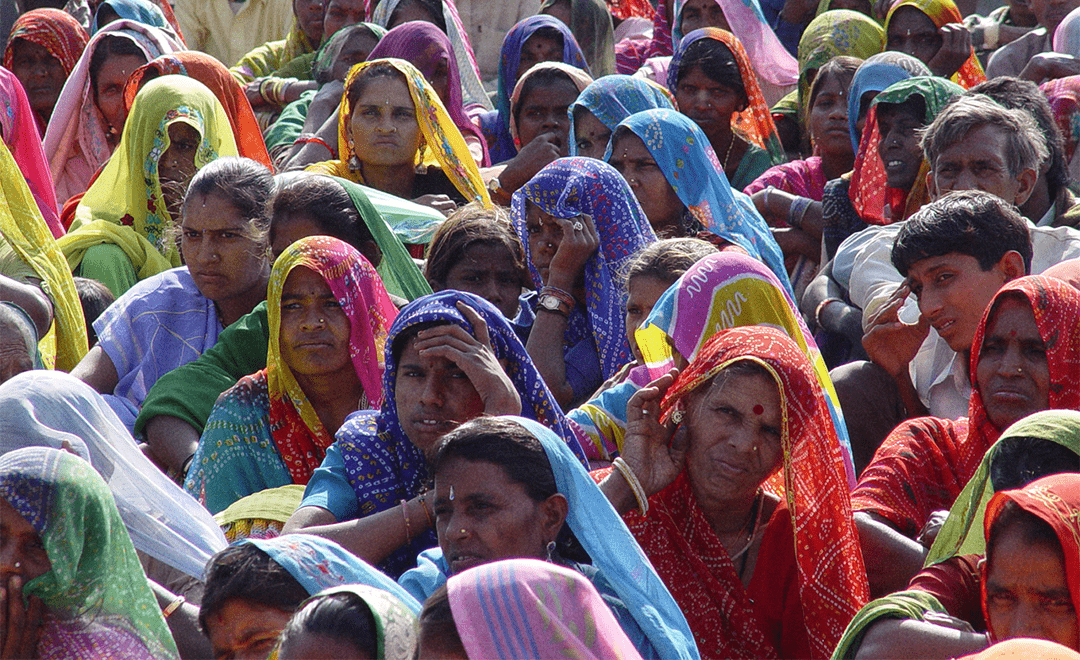An image showcasing a large group of Indian women sitting - highlighting gender upclose for UPES