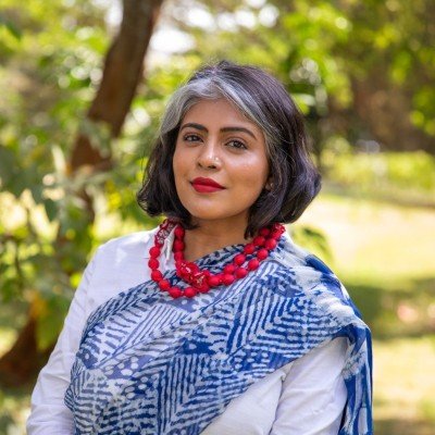 Photo of Nandita Surendran outdoors against trees in the background, who is one of the supporters of Newsworthy.Studio, a global social impact communications agency.